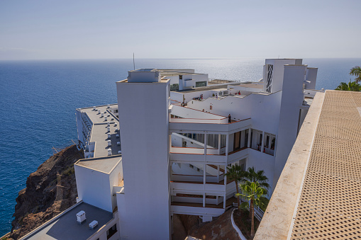 . Gran Canaria. Spain. 07.16.2023. Beautiful view of RIU hotel building on top of mountain on backdrop of Atlantic Ocean.