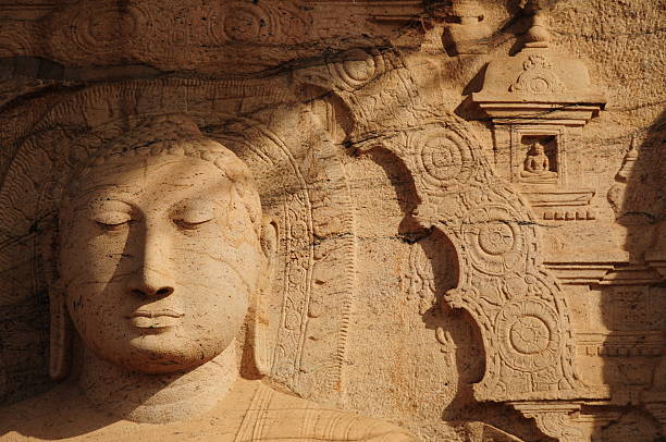 Telephoto image of majestically hand carved 1000 year old Buddha at Gal Vihara a World UNESCO site at sunrise.