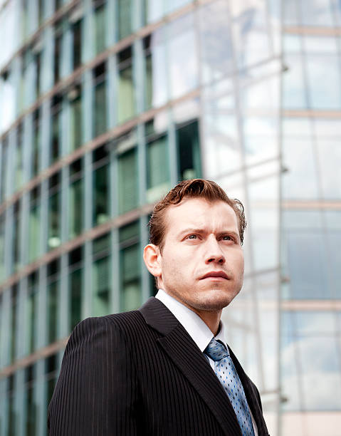 istock businessman in front of modern office building 155384284