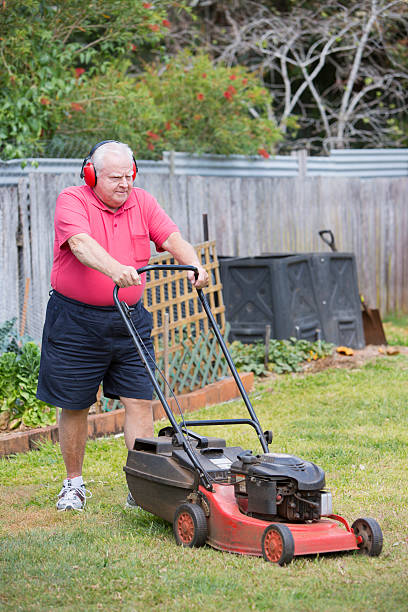 istock Senior Man Mowing the Lawn 155384443