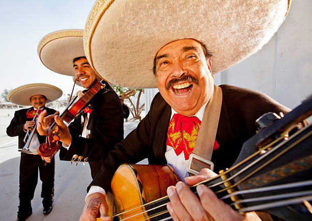 Three smiling members of a mariachi band stock photo