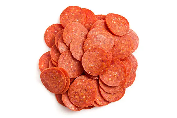 Heap of pepperoni on white background