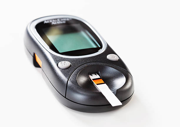 istock Test strip inserted into glucometer to measure blood sugar levels 155384920