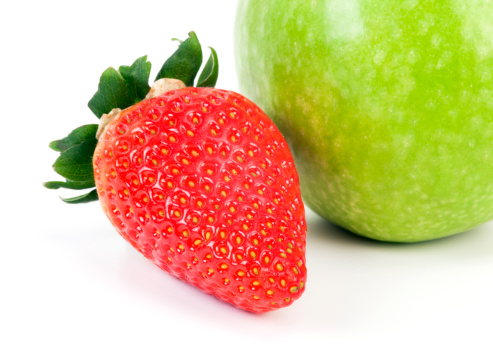 Strawberries and Apple on white background. Sweet fruits.