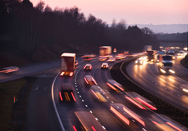 Busy traffic at dusk on the M42 Motorway near Birmingham Busy traffic looking west at dusk on the M42 Motorway. Shot from Junction 3, the A435 junction, just south of Birmingham.  multiple lane highway stock pictures, royalty-free photos & images
