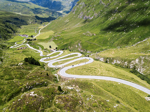 Drone image over the serpentine road through the Swiss Alps Julier Pass in summer