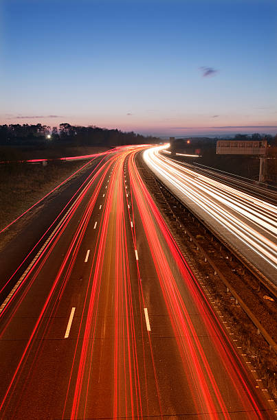 Busy motorway traffic trails at dusk