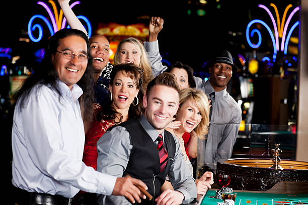 istock Large group of happy diverse people at the roulette table 155385680