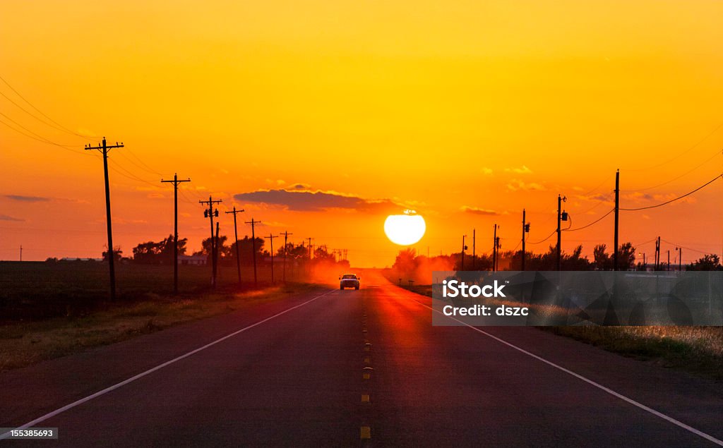 Pickup truck at sunset on West Texas country road Pickup truck heading home at sunset on West Texas country road. Texas Stock Photo
