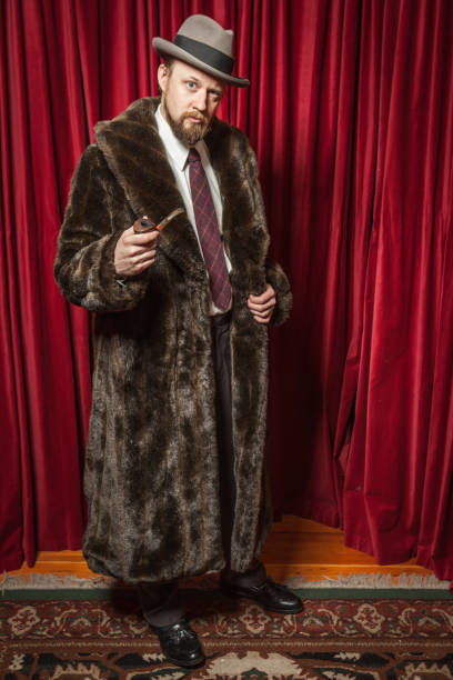 istock Standing Bearded Man Wearing Fedora, Fur Coat, Holding Pipe 155385699