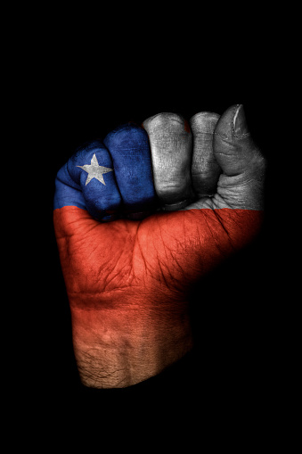 Image of a clenched fist with the flag of Chile on it