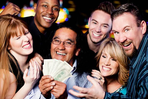 стокові фото, фото роялті-фрі та зображення на тему переможець: велика група щасливих різноманітних людей, які святкують перемогу - casino