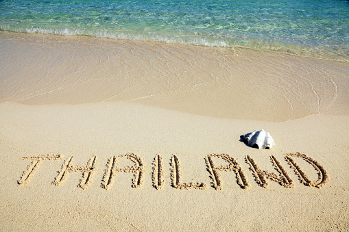 Thailand inscription written in sand on the beach