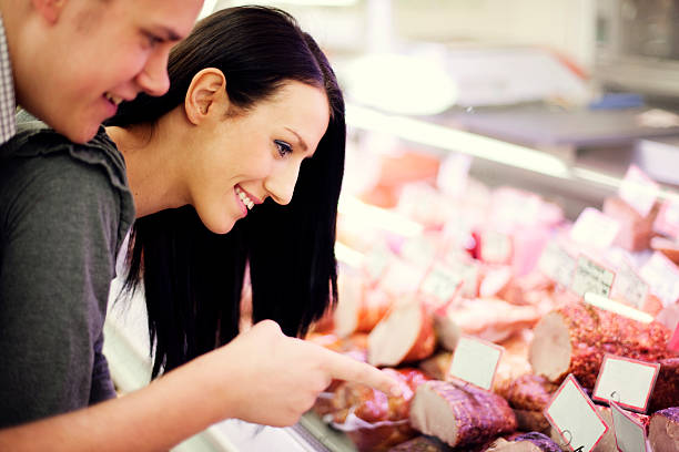 istock Young couple in butchers shop 155385938