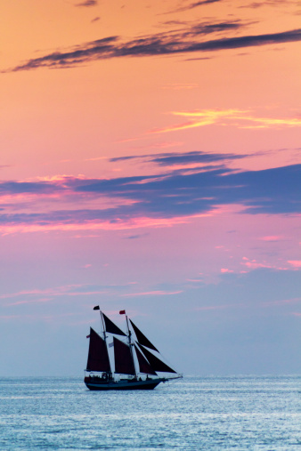 These sail boats take quiet advantage of the beautiful sunsets in Key West Florida. Even after the sun has set below the horizon, the colors in the sky and ocean abound.