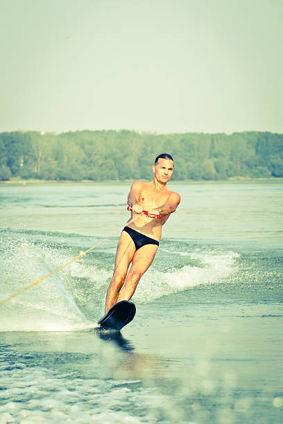 istock Mid-adult athlete waterskiing. 155386291