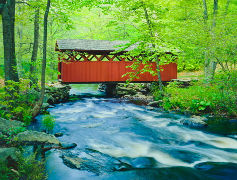 Chatfield Hollow covered bridge crosses a fast flowing stream in Chatfield Hollow State Park