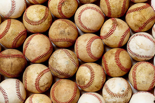 istock Background graphic of dirty baseballs with red lacing 155386889