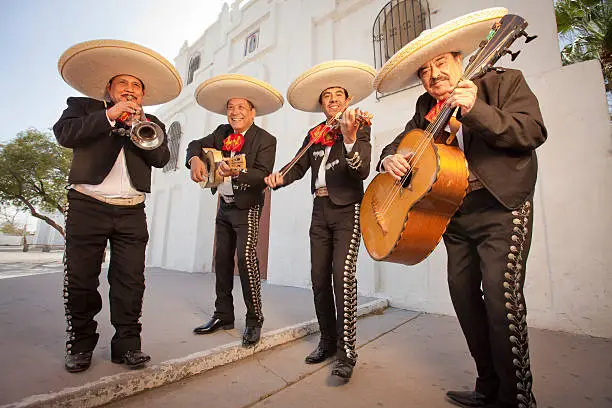 Four Musicians in tradition dress plating Mariachi music