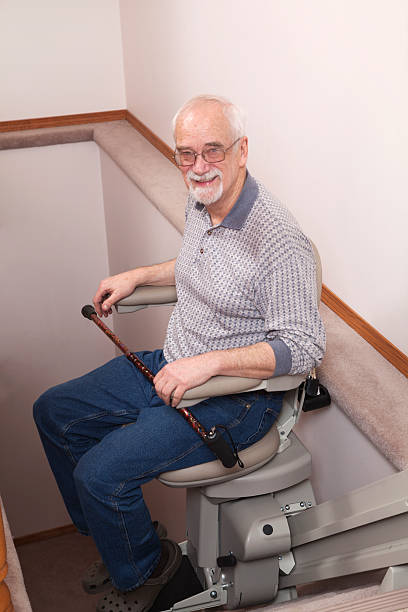 istock Senior using stairlift in home: Assisted Living 155387350