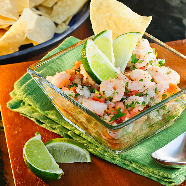 Close-up of tasty Ceviche cured with lime wedges stock photo