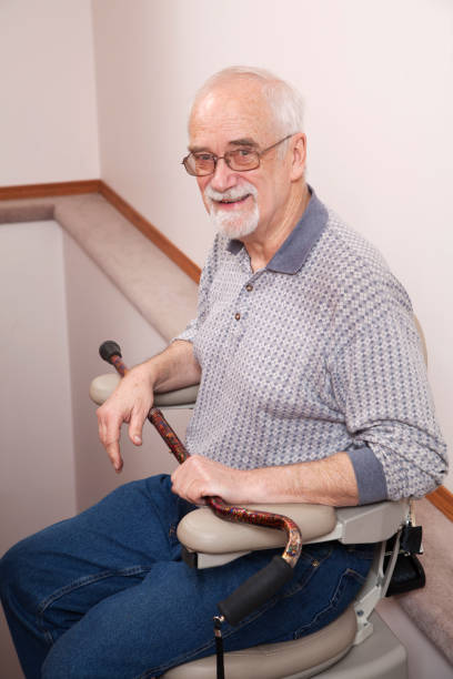 istock Senior using stairlift in home: Assisted Living 155387404