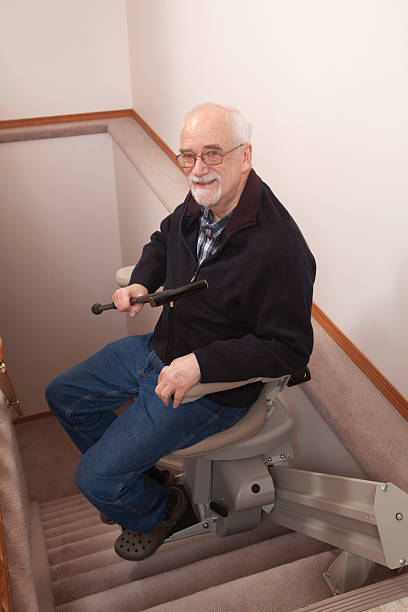 istock Senior using stairlift in home: Assisted Living 155387414