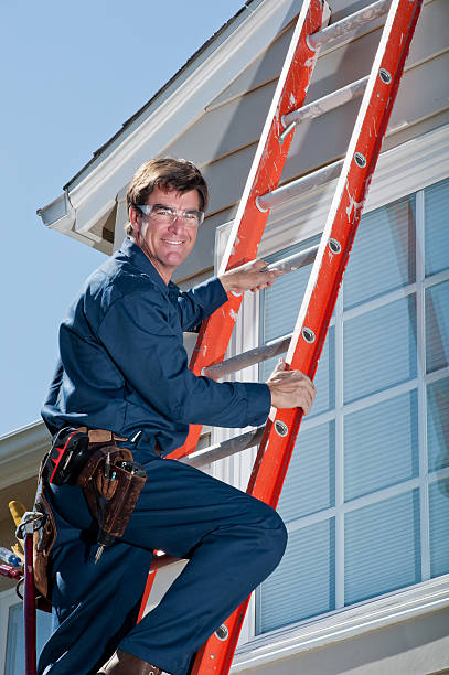 istock Handyman In Uniform Climbing Ladder 155387415