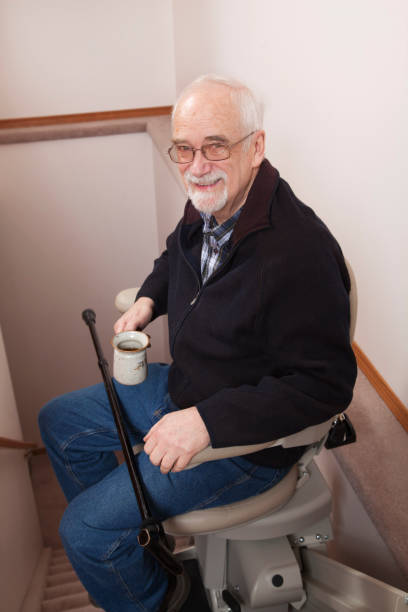 istock Senior using stairlift in home: Assisted Living 155387666
