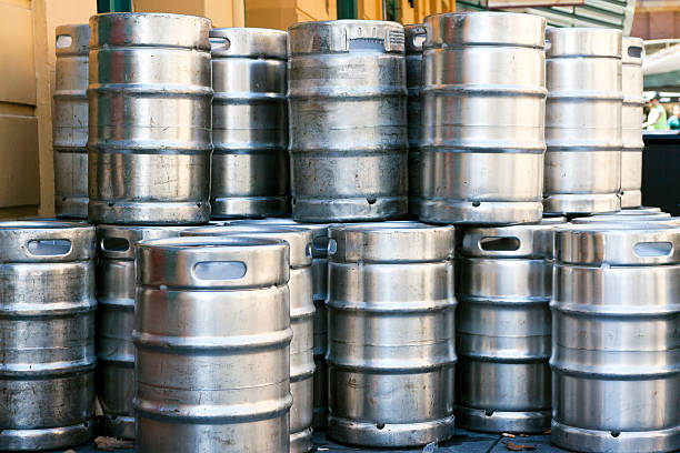 Stack of shiny stainless steel beer kegs outside of pub Stack of shiny stainless steel beer kegs outside of pub, full frame horizontal composition keg stock pictures, royalty-free photos & images