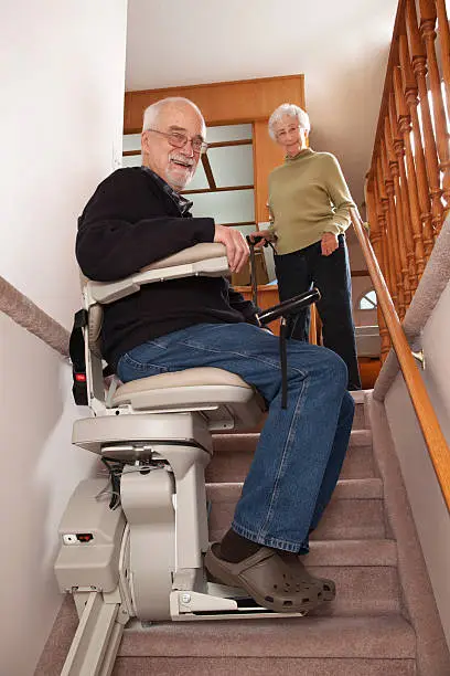 Photo of Cheerful Seniors with Stairlift: Assisted Living