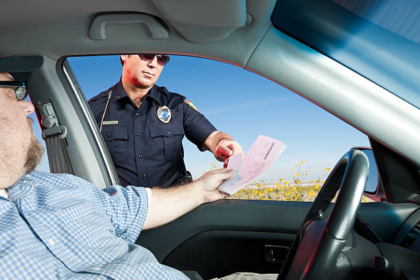 istock Motorist Handing Police License and Registration 155388016