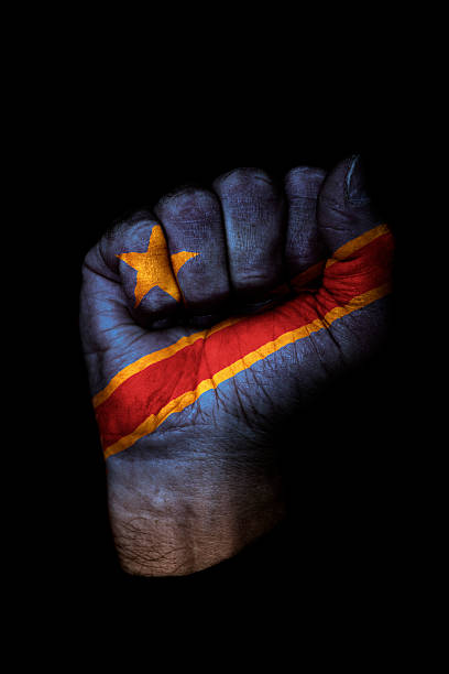 демократическая республика конго флаг кулак - congolese flag стоковые фото и изображения