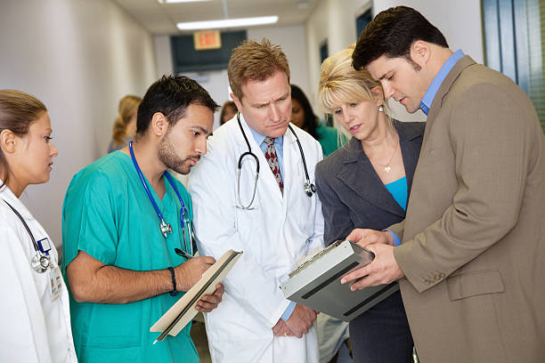 istock Hospital administrators talking to medical staff 155388548