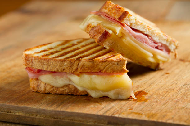 Panini Sandwiches Hot off the grill panini sandwiches made with crusty, hand sliced bread, black forest ham and swiss cheese. panino stock pictures, royalty-free photos & images