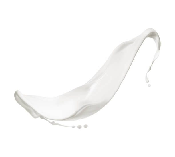 istock Gentle milk splash in the air isolated on white background 1553887700