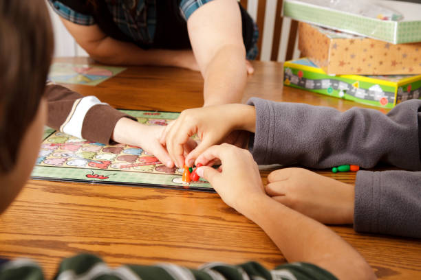 istock Family Playing A Board Game Together 155388841