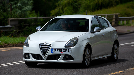 Milton Keynes,UK - July 19th 2023: 2011 white Alfa Romeo Giulietta car   travelling on an English road
