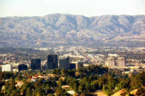 Santa Clarita Mountains in background as Warner Center in foreground with Woodland Hills, West Hills, Chatsworth, Norhtridge and Porter Ranch in between