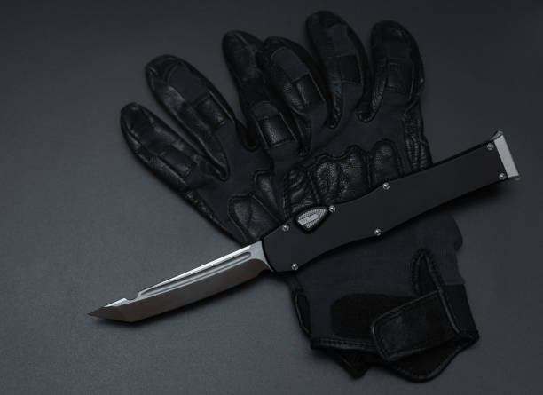 istock Kevlar gloves and pocket knife on the table 1553889923