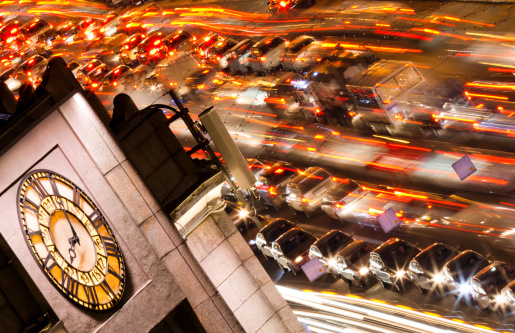 Time lape large clock Standing tall on a large city along with the letter time