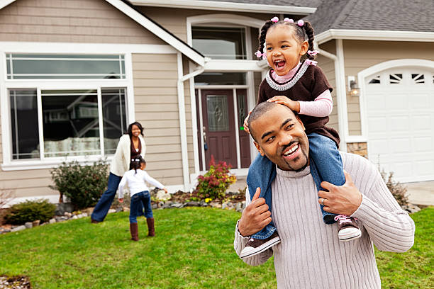 Playful Family of Four at Home Photo of a happy family of four playing in their front yard, focus on father and daughter in foreground. short weave hairstyles stock pictures, royalty-free photos & images