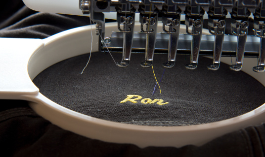 Close up of a embroidery machine just finishing a nickname on a garment