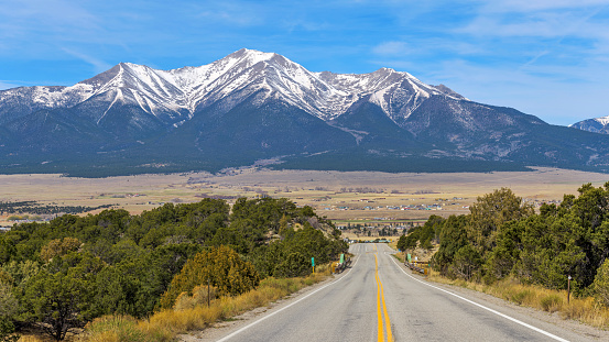 A panoramic Spring morning view of Snow-capped Mount Princeton towering above Buena Vista at Arkansas Valley, as seen from U.S. Route 285, Colorado, USA.