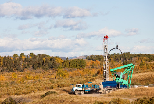 A drilling rig in oil field in Alberta, Canada. The oil industry and oilsands or tarsands are a major economic driver in Alberta. Fracking and other shale gas plays are also major industries. Natural gas and crude oil account for much of Alberta's exports. 