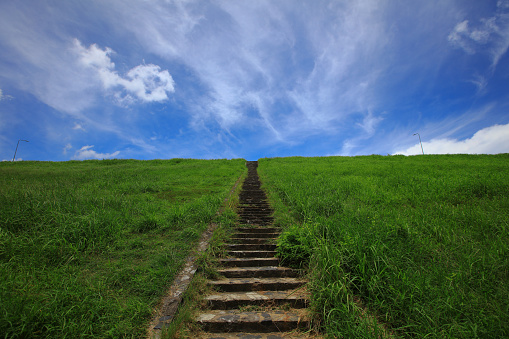 Natural background, line of stairs from the ground up to of the mountain