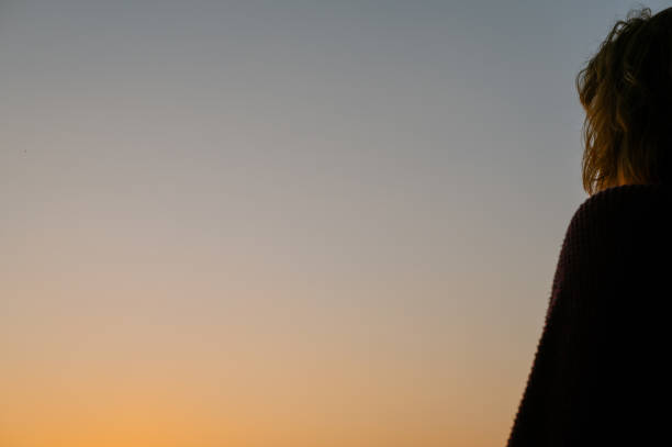 istock Side view of person seen standing during dusk 1553902273