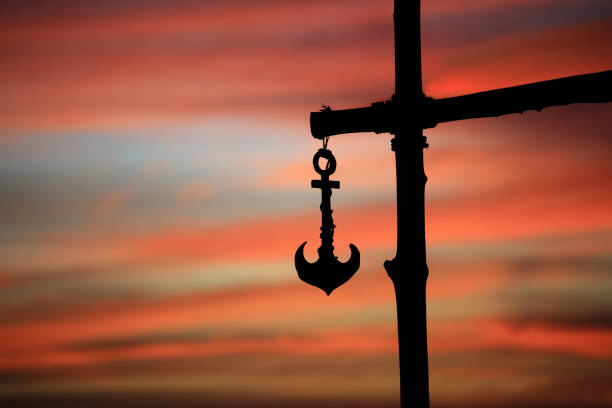 Silhouette Hanging of Anchor against sunset sky