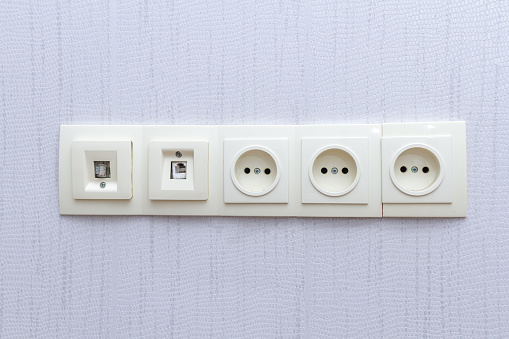An electrical outlet on white wall