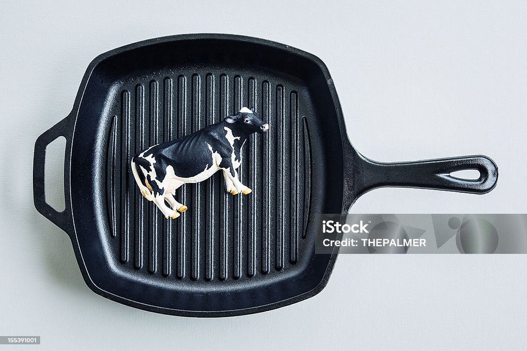 cow toy on cast iron pan Animal Stock Photo